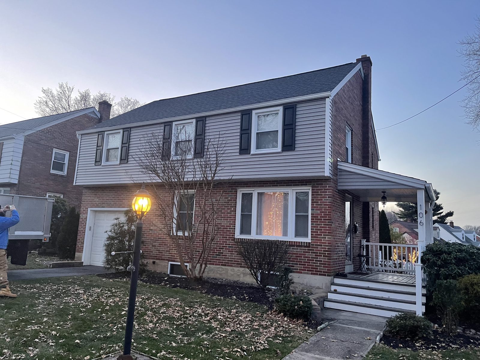 Brick two-story home exterior with new windows in Mohnton, PA