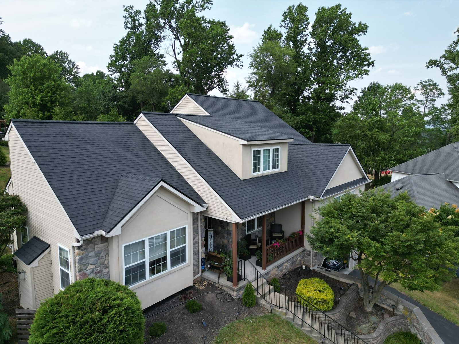 New roof over a covered-porch home, drone view, Mohnton, PA