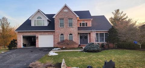 Brick home gray roof landscaped exterior — New Holland, PA