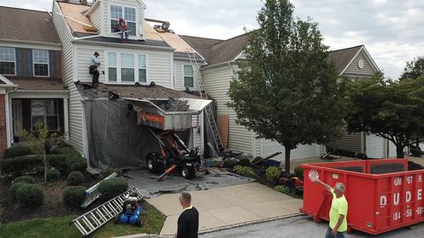 Brick home roof replacement dumpster jobsite — Phoenixville, PA