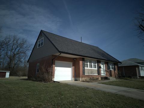 Brick cape cod home new roof, side view