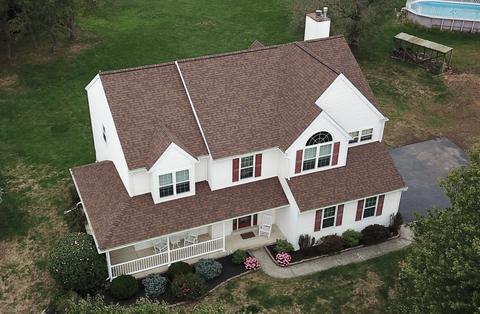 Drone view brick home gray roof — Phoenixville, PA