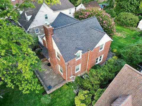 Drone view brick home shingle roof — Phoenixville, PA