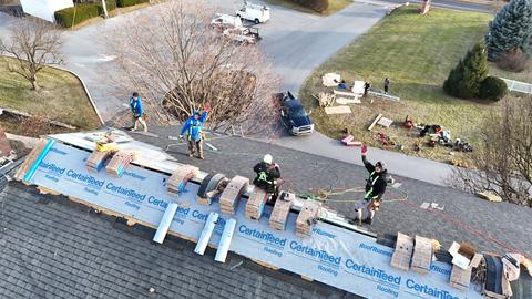Drone view commercial roof crew aerial — New Holland, PA
