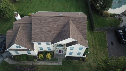 Drone view home gray roof wooded — Phoenixville, PA