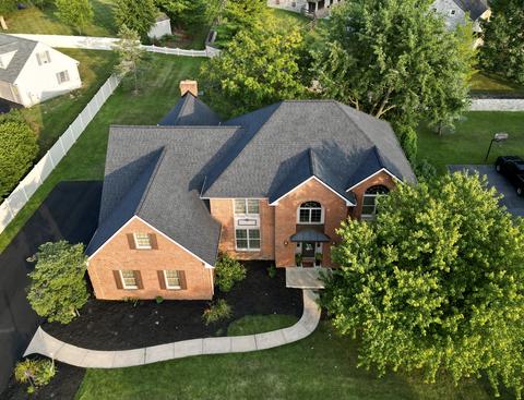 Drone view large brick home gray roof — New Holland, PA