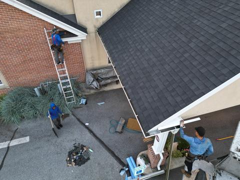 Drone view roof replacement crew ladders — New Holland, PA