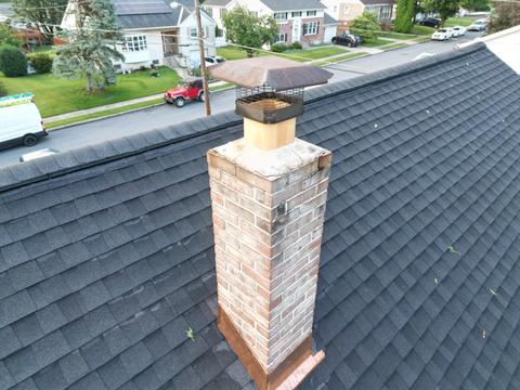 Drone view shingle roof chimney detail — Shillington, PA