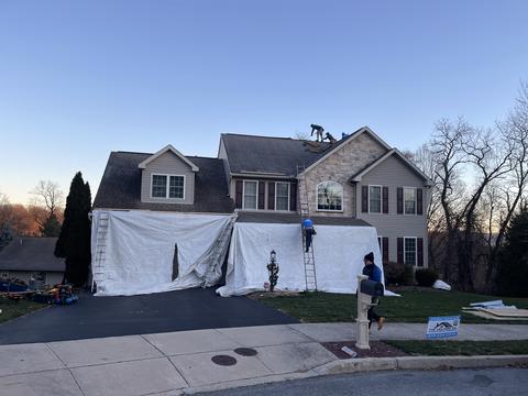 Home roof tarp containment crew dusk — Wyomissing, PA