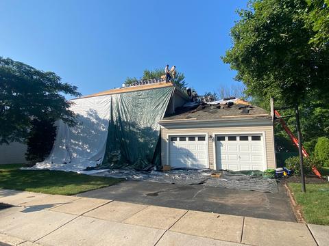 Storm damage roof tarp debris driveway — Phoenixville, PA