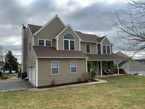 Tan two story home exterior new roof — Phoenixville, PA
