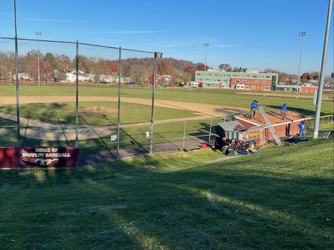 The Helping Co. baseball field banner