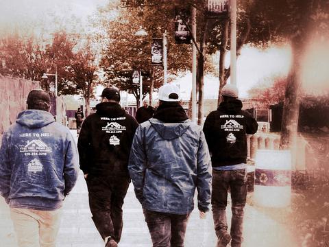 The Helping Co. team walking branded shirts